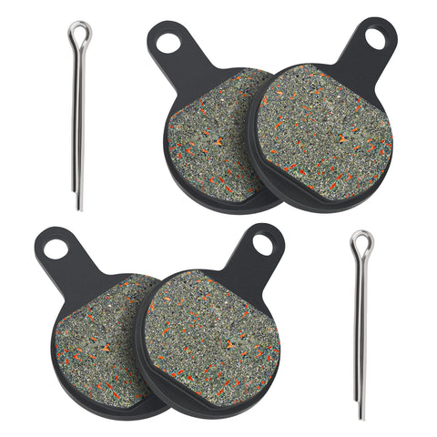 Front view of four Tektro IOX disc brake pads with mounting tabs and two metal pins.