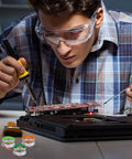 Person soldering a PCB with Six Piece Solder Wick Braided No Clean Desoldering Wicks Set in multi color for electronics repair.