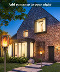 Solar Torch Lights With Realistic Flickering Flame 96 LEDs 43 Inch Outdoor Waterproof Landscape Lights illuminating a patio