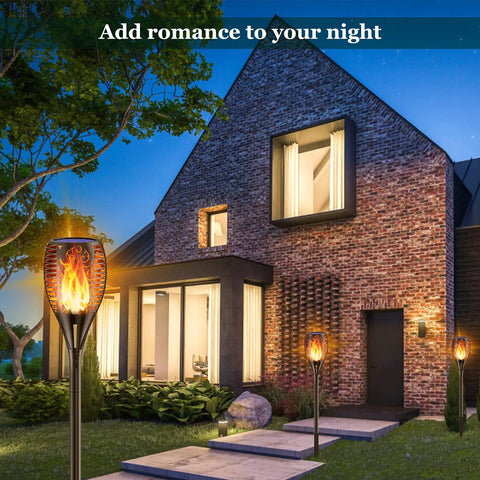 Solar Torch Lights With Realistic Flickering Flame 96 LEDs 43 Inch Outdoor Waterproof Landscape Lights illuminating a patio