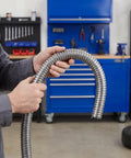 Person holding Built Tough Stainless Steel Flexible Wire Conduit For Electrical Cable Routing And High Temperature Rugged Metal Tubing.
