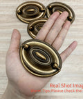 Person holding 4 Pcs Antique Brass Bail Drawer Pulls Oval Drop Swing Handles For Dresser And Cabinet, Zinc Alloy Hardware, 2.32 Inch Hole