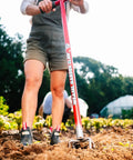 Person using a Long Handle Garden Claw For Easy Weeding And Soil Aeration No Bend Tiller Cultivator in a vegetable garden