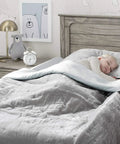 Toddler sleeping safely with Two Pack Extra Long Foam Bed Bumpers For Toddlers And Kids Expands To 56 Inch Coverage After Unrolling