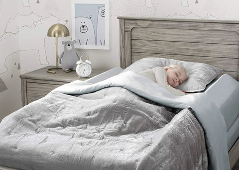 Toddler sleeping safely with Two Pack Extra Long Foam Bed Bumpers For Toddlers And Kids Expands To 56 Inch Coverage After Unrolling