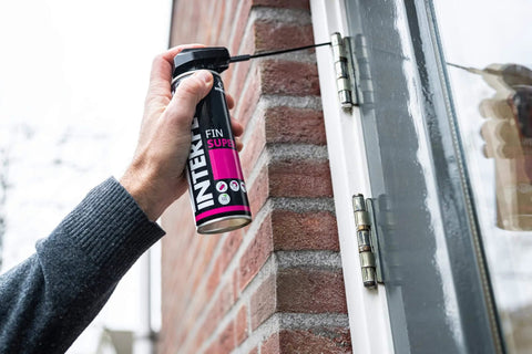 Person applying Fin Super Industrial Oil Lubricant Spray With Penetrating Dry Film Action, Teflon Free And PFAS Free, 300ml Aerosol on a door hinge.