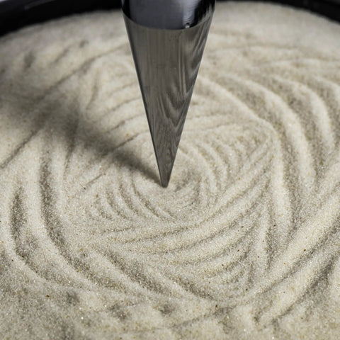 Close-up of Dope Pendulum Demonstration Kit creating intricate sand patterns showing Earth's rotation with every swing.