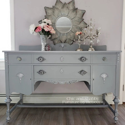 Gray dresser painted with Manatee Gray Chalk Finish Furniture Paint for DIY Lovers, showcasing matte mineral finish and decor details.
