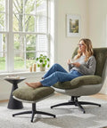 Woman relaxing in Oversized 360 Degree Swivel Accent Chair With Ottoman, Heavy Duty 400 Lbs Capacity, in grey in modern living room.