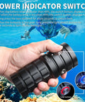 Beast Bright 25000 Lumens Underwater Dive Light held underwater, showing power indicator switch with color-coded statuses