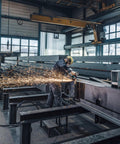 Worker using 5 Inch Brushless Angle Grinder 2000 Watt Pro Grade Workhorse in industrial setting, sparks flying