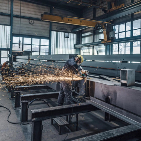Worker using 5 Inch Brushless Angle Grinder 2000 Watt Pro Grade Workhorse in industrial setting, sparks flying