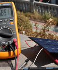 Mini USB Solar Panel Module 2W 6V With Blocking Diode, connected to a multimeter outdoors, showcasing charging capability