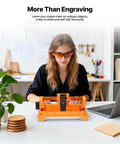 Desktop 3.5W Laser Engraver And Cutter Machine Featuring Plug And Play Design at workbench with hobbyist using it.