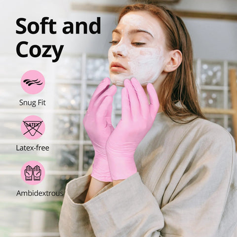 Pink latex-free nitrile ambidextrous gloves, front view of person applying a facial mask.