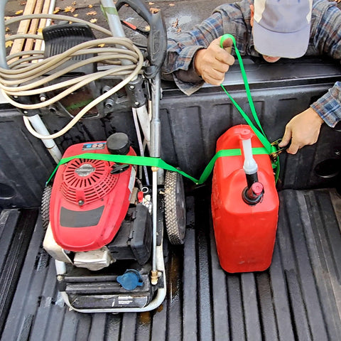 Person using Two Pack Truck Bed Anchor Kit For Tailgate to secure cargo with ratchet straps in truck bed.