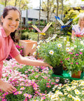 Woman placing Dope Dragonfly Clip 12 Pack For Garden Decor And Outdoor Stakes into colorful flower pots in garden setting