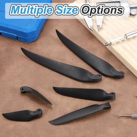 RC Glider Propeller Replacement Prop Blades 6x4 Inch Nylon Folding Propeller in multiple sizes, black, laying on table