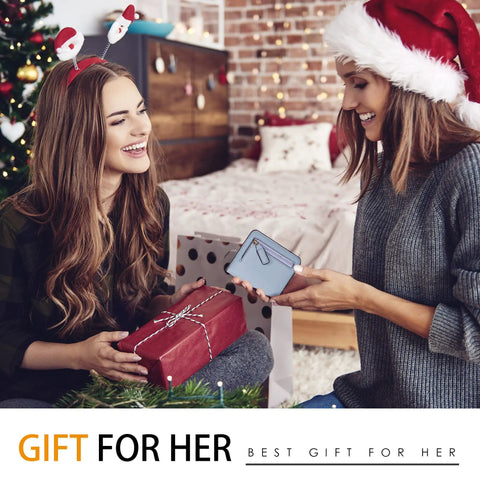 Two women exchanging gifts, one holding a Women’s Slim Leather Wallet With RFID Protection, Compact Bifold Purse, in a festive setting.