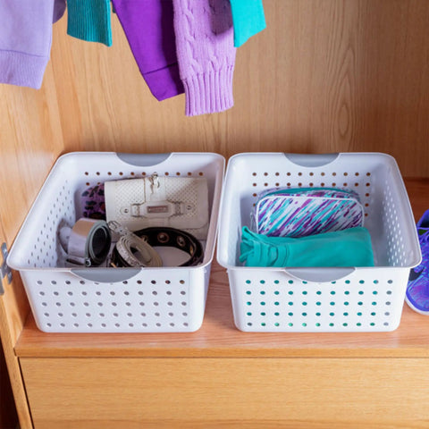 Two white baskets with contoured handles in a cabinet, part of Large Ultra Storage Baskets Pack Of 6 For Closet, Cabinet, And Pantry Organization