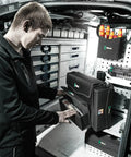 Person using 2Go 2 Tool Container For On The Go Gear Organization in a service van, featuring durable storage and quick access slots.