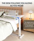 Go To Overbed Table On Wheels With Pneumatic Lift next to a bed, showing 90-degree adjustment and lamp on bedside table