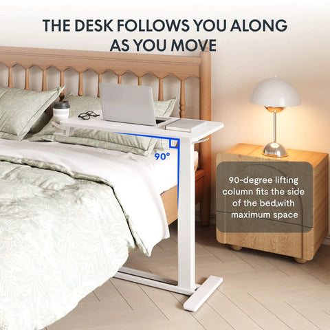 Go To Overbed Table On Wheels With Pneumatic Lift next to a bed, showing 90-degree adjustment and lamp on bedside table