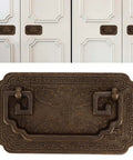 Antique Bat Style Brass Drawer Pull Handle With Two Screws for cabinets, showing intricate details and brass finish on white doors.