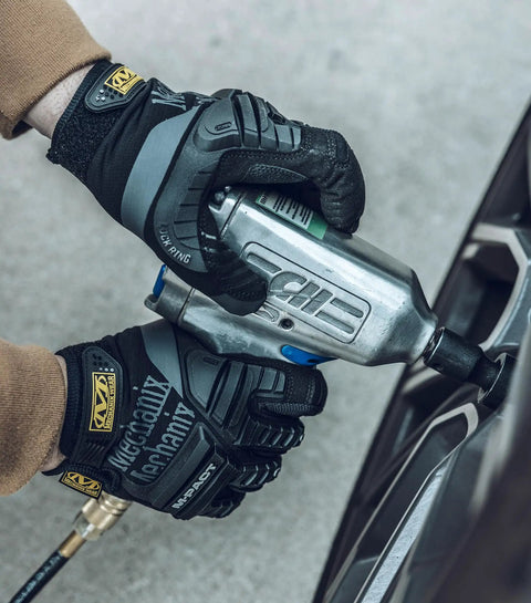 Mechanic wearing MPact Impact Resistant Work Gloves With D3O Palm Padding, Touchscreen Ready, Black, Large while using power tool