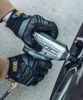 Person using power tool wearing MPact Work Gloves With Secure Fit, Impact Protection And Vibration Absorption For Tough Jobs, Safety Gloves For Men Gray Large, Rugged 0.8mm Synthetic Leather, Touchscreen Enabled