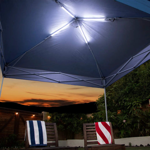 Link Light System For Canopies 4 Pack 20 Inch Light Bars illuminating under a blue canopy at sunset in a garden setting