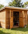 Wooden shed secured with Four Pack Thirty Inch Triple Helix Ground Anchors Kit With Fifty Foot Three Sixteenth Inch Galvanized Cable.