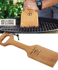 Person using the Ultimate Bbq Cleaning Tool Shovel With Hardwood Grill Scraper And Long Reach Comfort Grip Handle on a grill.