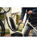 Person securing bike with 100 cm Plug-In Chain Bike Lock With 5.5 MM Hardened Steel Links Built Tough For Bicycles And Scooters