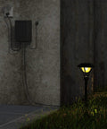 200W Low Voltage Outdoor Transformer With Weatherproof Housing And Photo Sensor For Landscape Lighting installed on a wall.