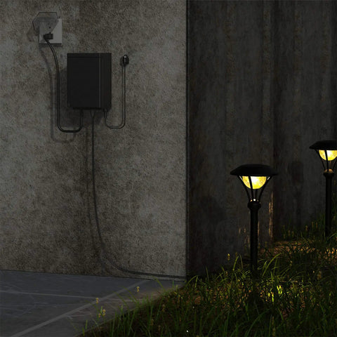200W Low Voltage Outdoor Transformer With Weatherproof Housing And Photo Sensor For Landscape Lighting installed on a wall.