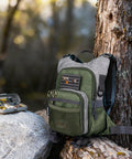 Fly Fishing Chest Pack With Workstation And Quick Release Lightweight Tackle Bag outdoors by a tree and rocks.