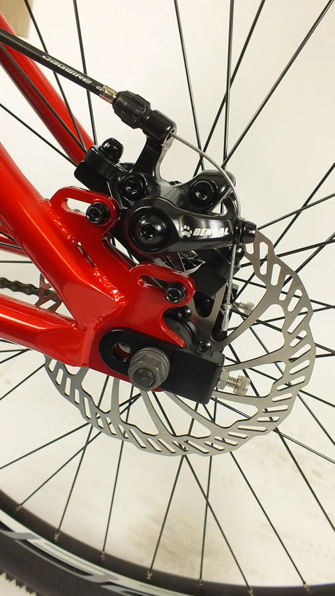 Close-up of Salire SJ-50 Dirt Jumper Bike With Disc Brakes And 26 Inch Wheels, highlighting beefy steel frame and brake mechanism.