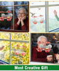 Window Mounted Hummingbird Feeder With Strong Suction Cups Bee Proof Ports Ant Moat And Dual Sun Shades Two Point Six Ounces Capacity Easy To Fill And Clean For Close Up Bird Watching installed on window with people watching.