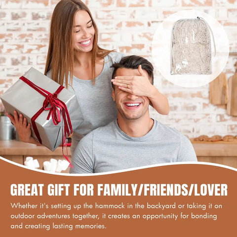Smiling couple with wrapped gift and Mayan Style Handwoven Rope Hammock For Two With Carry Bag Cozy 120 Inch Long By 67 Inch Wide Bed 500 Pound Capacity Multi Color Handmade Family Hammock For Travel Camping Backyard Porch Outdoor Indoor Use.