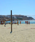 All Weather Outdoor Volleyball Net Beefy Heavy Duty For Backyard Beach Or Poolside Play Regulation 32x3 Feet installed on sandy beach.