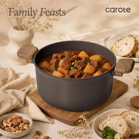 27 Piece Nonstick Pots And Pans Set With Detachable Handle holding stew, shown on a wooden board with bread and nuts