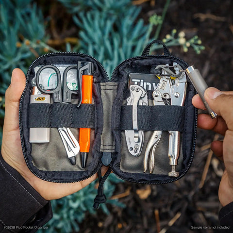Pico Pocket Organizer Ultra Compact EDC Gear Pouch open showing tools and gadgets inside, held in hand outdoors