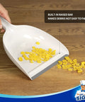 Portable Dustpan and Brush Set With Bamboo Handle in White for Quick Cleanups at Home, showing debris on dustpan with raised bar
