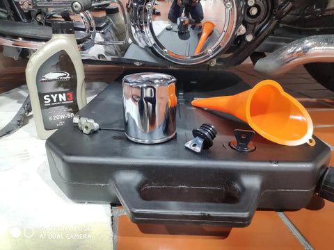 Universal Motorcycle Low Profile Oil Drain Pan With 10 Quart Capacity For Easy Oil Changes Slides Under Bikes And ATVs Easily Collects Waste Oil Great For Honda Yamaha Suzuki Kawasaki And More with funnel, oil bottle, and filter on garage floor