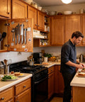 Man preparing food in kitchen with magnetic knife holder, illustrating Six Pack Magnetic Cabinet Locks Self Adhesive For Quiet No Noise Furniture Closure Flush Mount Design Keeps Cabinets And Drawers Closed Kid Safe Easy To Install Heavy Duty Magnetic Hold For Home Kitchen And Office applications.