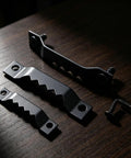50 Pack Small Sawtooth Picture Hangers With Screws, Black Steel Hanging Hardware Kit For Photo Frames, shown on wood surface