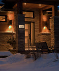 Solar Powered LED Address Sign For Outdoor Use With 3000K Warm White Light on house wall at night, showing illuminated numbers.