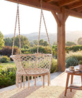 Macrame Hammock Chair With Tassels, Cozy Boho Hanging Swing For Indoor Or Outdoor Use, One Point Or Two Point Installation, Beige on patio