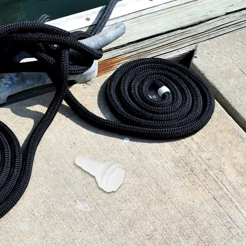 Marine Thru Hull Drain Outlet For Boats And Yachts with coiled black rope on dock